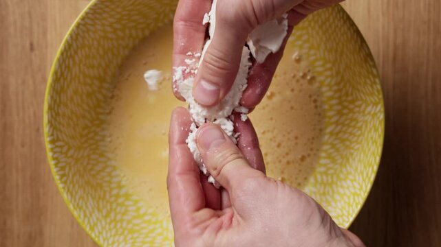 Crumbling Feta Cheese Into Bowl Top View
