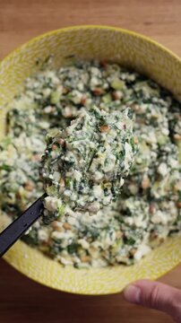 Greek Spinach Feta Pie Filling On Spoon Close Up Top View Vertical
