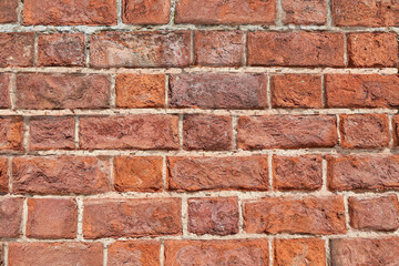 Fototapeta premium A red brick wall in closeup background