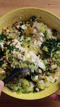 Mixing Greek Spinach Feta Pie Filling In Bowl Top View Vertical
