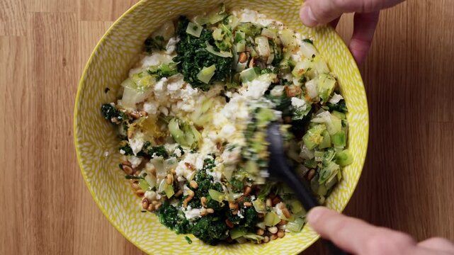 Mixing Greek Spinach Feta Pie Filling In Bowl Top View