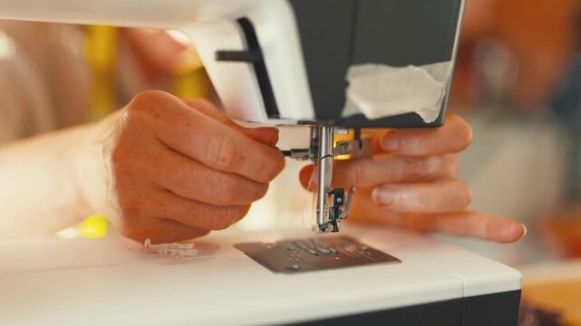 Learning to sew with a sewing machine in a workshop during the afternoon
