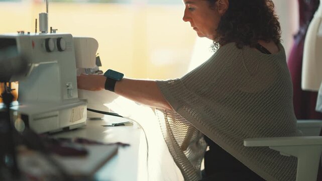 Working on a sewing project in a bright studio with natural light during the afternoon
