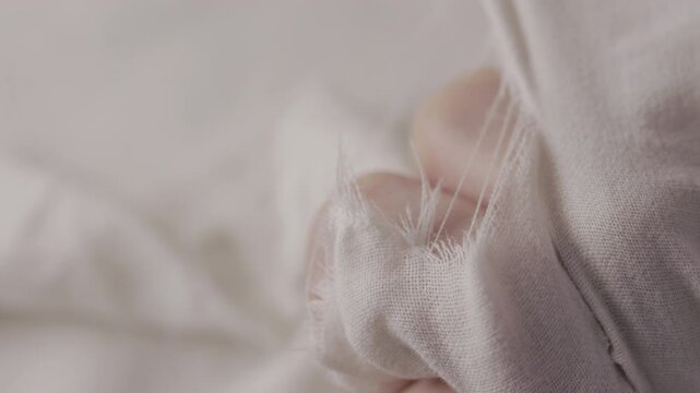 Ripped  white cotton fabric detail