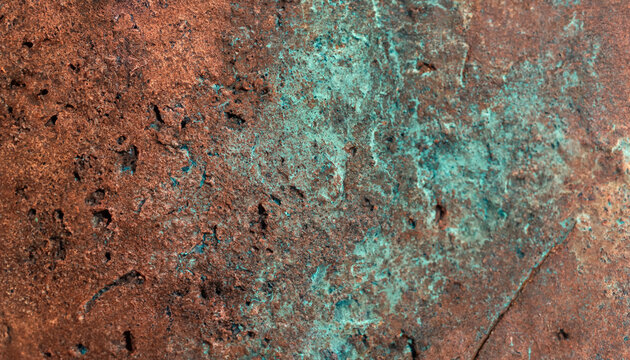 Close-up detail of weathered copper sheet showing chemical oxidation with blue-green verdigris and dark brown patina oxidation verdigris corrosion weathered abstract background material