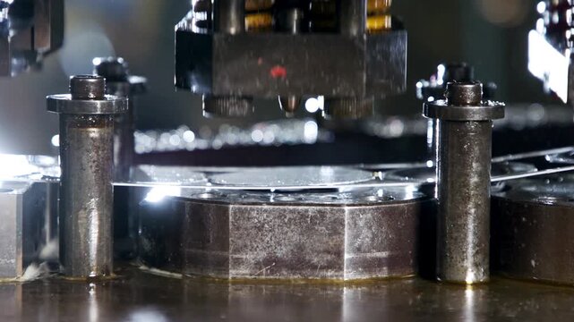 Closeup of industrial metal stamping machine processing a thin metal sheet
