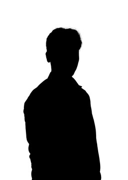 Silhouette of a young man standing against a white background