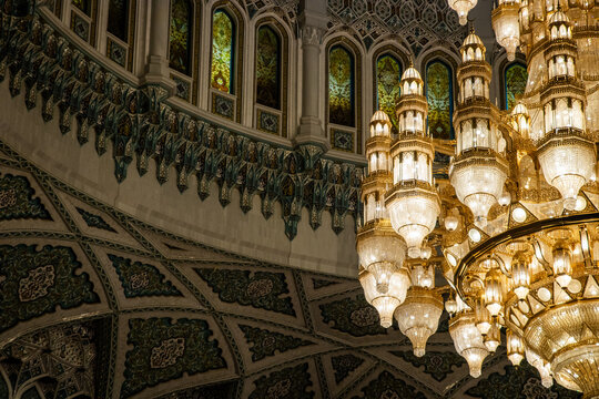 View of the ornate interior of the Sultan Qaboos Grand Mosque featuring a massive crystal chandelier and intricate mosaic patterns Muscat, Muscat Governorate, Oman.