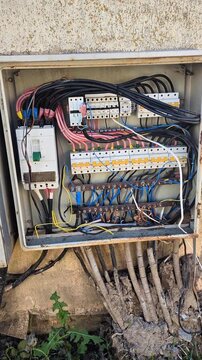 Devastated residential electrical panels caked in mud, debris, and silt after a catastrophic flood
