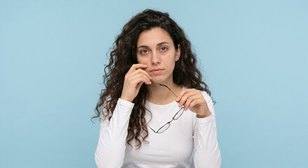 Fototapeta premium Portrait of an exhausted young woman, showing symptoms of stress, depressed mood or chronic fatigue