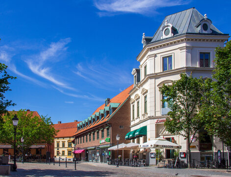 Ystad, Sweden - June 23 2019: Sunny town square with historic buildings and outdoor cafes in Ystad Sweden