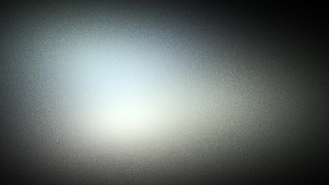 Cool silver light diffusing across a dark grainy surface