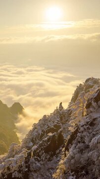 Sunrise time lapse looking out over a sea of fog at the Yellow Mountains (Huangshan) in China. Vertical video.