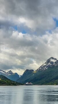 Time lapse of the clouds moving above the  amazing coastline and mountains of Norway. Vertical video.