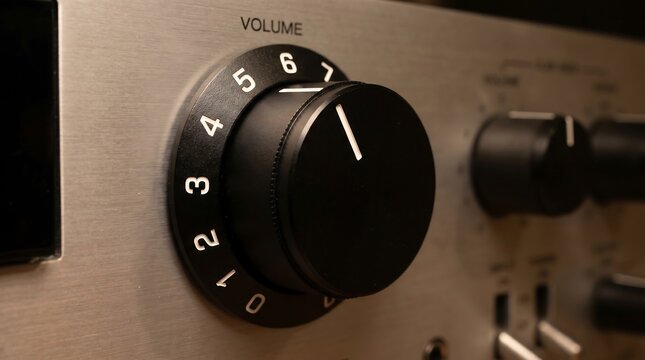 Vintage silver amplifier volume knob, brushed metal stereo receiver control panel, retro hifi audio equipment with numbered dial