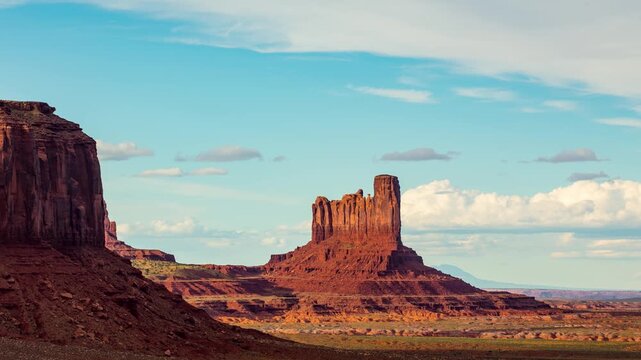 Time Lapse of beautiful clouds behind the rock formations of Monument Valley