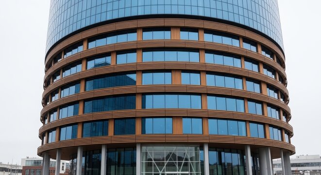 Modern cylindrical building with colorful window frames and structural supports