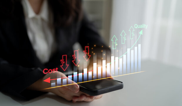 Businesswoman Analyzing Financial Growth Trends With Smartphone Showing Cost And Quality Metrics In Modern Workplace Setting. Bitwise.