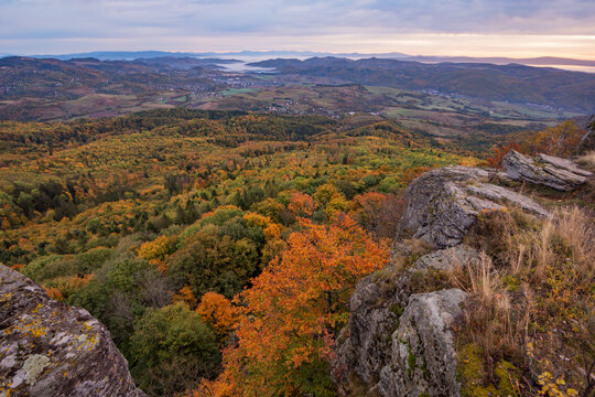 View of autumn forest and rolling hills from the rocky peak of Sitno in the Stiavnicke vrchy mountains Ilija, Banska Bystrica Regio, Slovakia.
