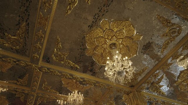 Beautiful golden interior of the Glass Vihara at Wat Phuttha Phrommayan temple in Chachoengsao, Thailand.