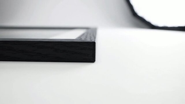 Minimalist black wooden frame close-up, modern interior decor detail, empty blank frame mockup for or display