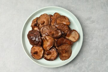 Fototapeta premium Tasty cooked shiitake mushrooms served on light grey table, top view