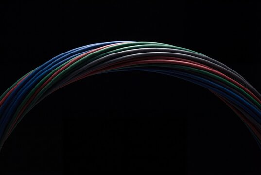 Minimal Arc of Color-Coded Network Cables on a Dark Background
