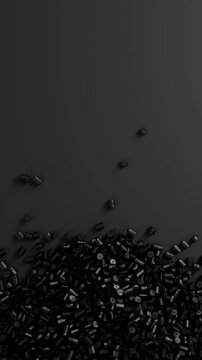 Close-up top view of rotating black polypropylene plastic granules and masterbatch resin pellet pile, 3D render seamless Vertical video.