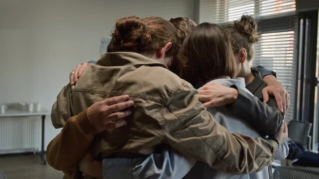 Diverse group hugging in circle during therapy session. Footage for mental health awareness and support group advertisements