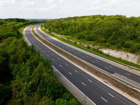Aerial view above a deserted UK motorway through countryside