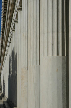 An extreme close up view showing the texture and fluting of white marble columns at the Stoa of Attalos in Athens