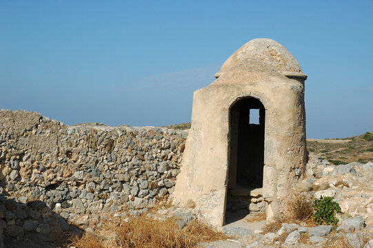 Historic stone watchtower guardhouse on the Venetian castle wall of Chora in Kythira island Greece under clear blue sky