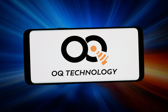 Stuttgart, Germany - 06-15-2026: In this photo illustration, the logo of satellite communication company OQ Technology is displayed on a smartphone in front of abstract background on computer screen.