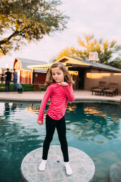 Girl posing by pool