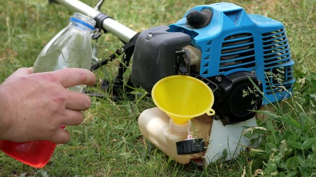 Pouring Fuel and Oil Mixture into Brush Cutter Tank Outdoors