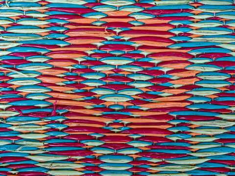 Detail of the patterns in a colorful woven plastic floormat