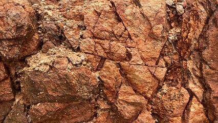 Rugged rock surface texture, close up of red stone cliff © Epiko
