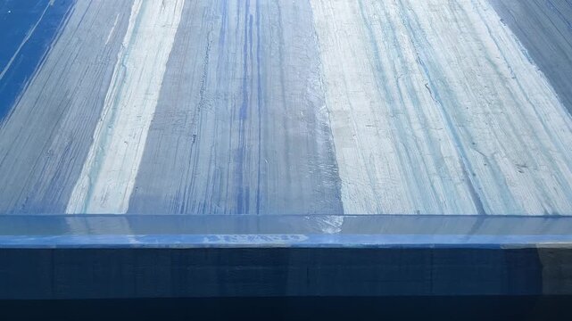 Close up of blue and white painted textured surface with brush strokes