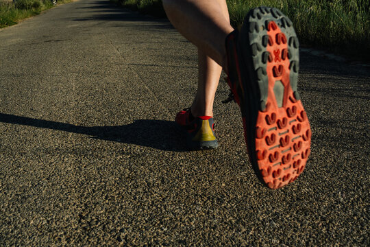 Runner exercising on road with trail running shoe