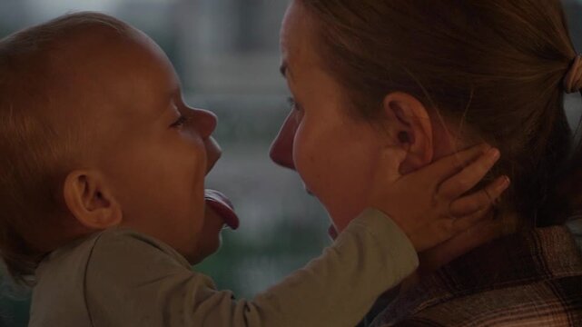 Caucasian mother and daughter embracing closely touching foreheads , expressing comfort, trust, emotional support. Useful parenting, family care, bonding, mental wellbeing themes, child having fun