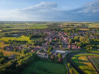 Summertime aerial view of old English village, Wainfleet, traditional village in England, UK Lincolnshire. Serene Landscape with Lush Greenery and Charming Homes Captured from Above. © MD Media