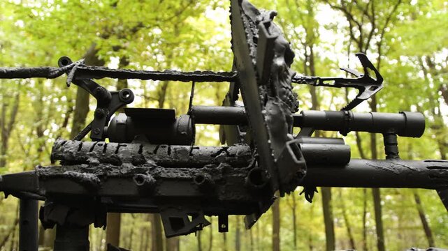 Forest setting, heavy armor, aggressive design. Detailed shot showing metallic, armored structure with aggressive, sharp attachments in wooded, post-apocalyptic setting.