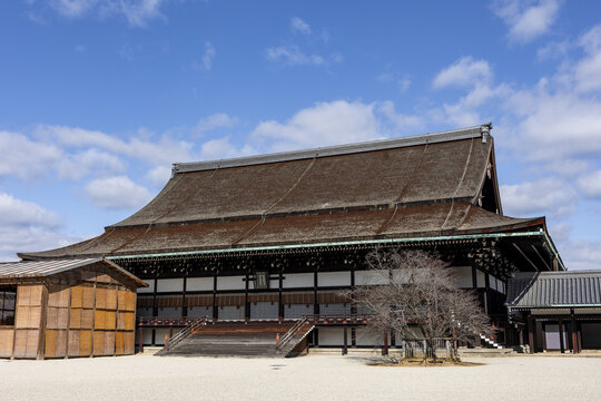 View of the traditional Japanese architecture of the Shishinden hall at Kyoto Imperial Palace with its large thatched roof under a blue sky Kyoto, Kyoto, Japan.