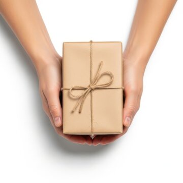 Two human hands holding a small cardboard gift box wrapped with brown string isolated on white background
