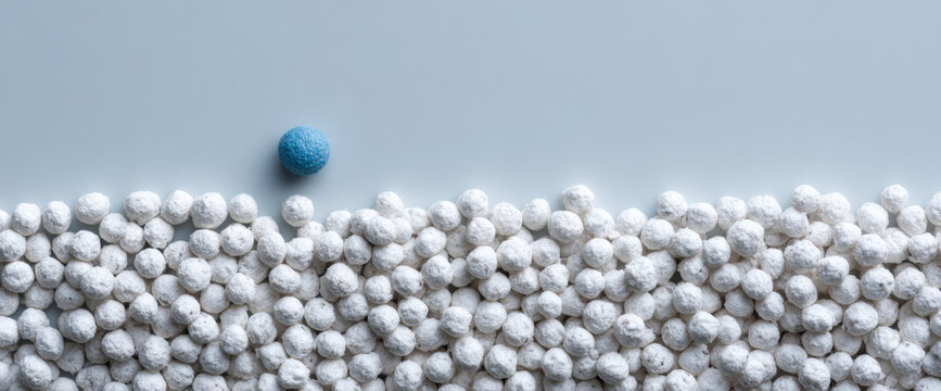 Single blue ball among white balls