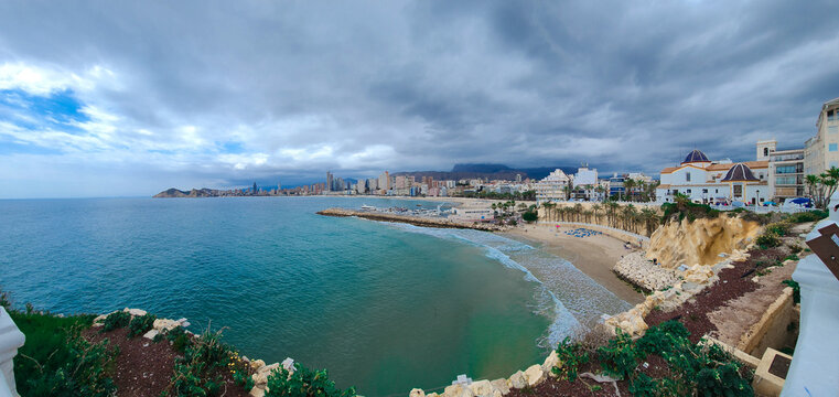 Panoramic view of dramatic cloudy sky over Benidorm tourist city and beach