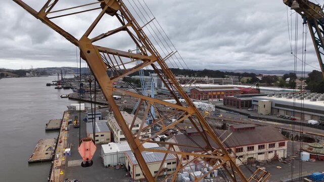 VALLEJO, CALIFORNIA, USA - JUNE 19, 2026: Aerial view of an empty dry dock, a floating crane and historic buildings at the Mare Island shipyard along the Mare Island Strait.