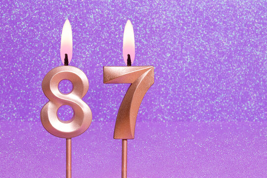 Number 87 on a pink background with blurred bright dots - Birthday or anniversary card with abstract blurred dots that glow