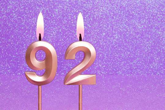 Number 92 on a pink background with blurred bright dots - Birthday or anniversary card with abstract blurred dots that glow
