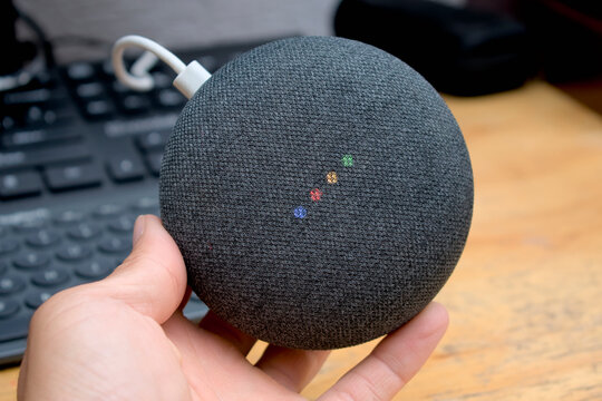 Zapopan Jalisco, Mexico - June 19, 2026: Google Home Mini smart speaker held in hand with glowing LED status lights, smart speaker concept